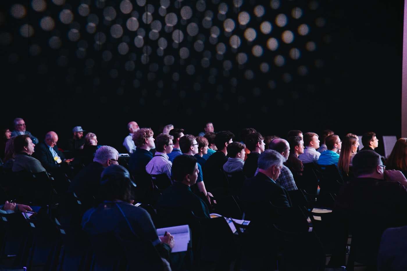 A packed conference audience at an international event